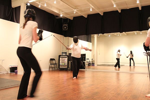 Kajetan and author fencing in a dance studio, with rapiers, with a large mirror in the background
