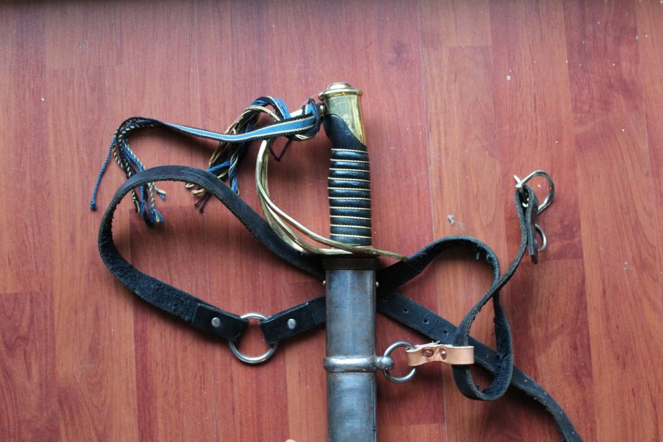 Sabre on a hardwood floor, attached to belt